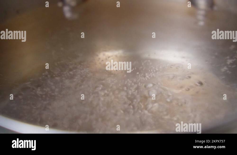Process of Boiling Water, Closeup. Bubbles Of Boiling Water in A Steel