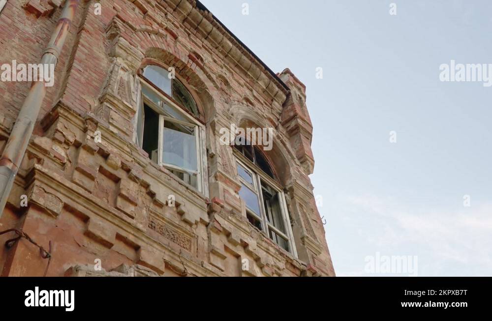 an old ruined building against the sky. broken glass in the windows ...