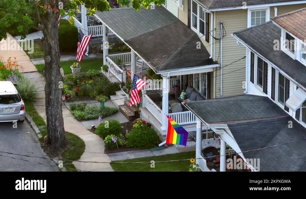 Overhead shot of modest family homes in small town America. Pride flags