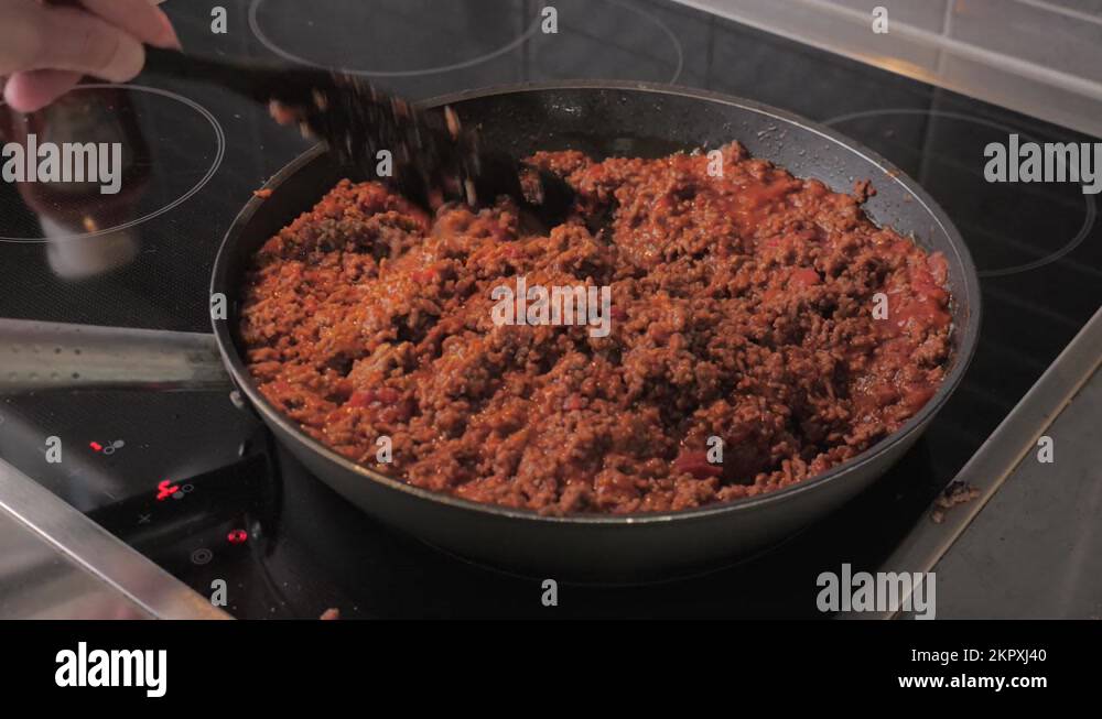 Chef stir and fry minced meat in a frying pan Stock Video Footage Alamy