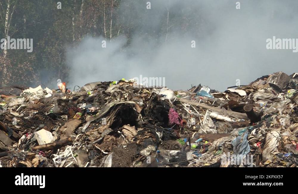 Burning garbage dump, toxic smoke rises into the air, polluting the