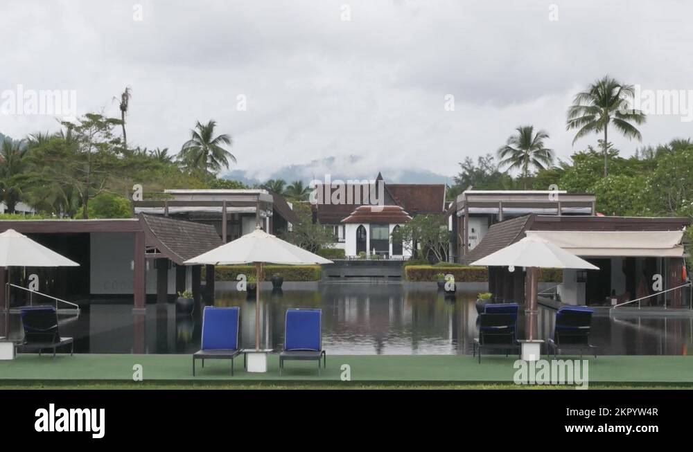 luxury beach lounge beds with umbrella near swimming pool in resort in
