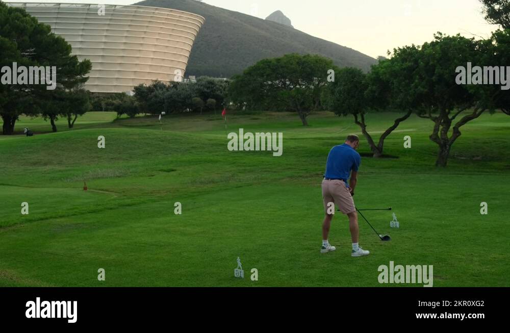 Male golf player teeing off golf ball . cape town, south africa
