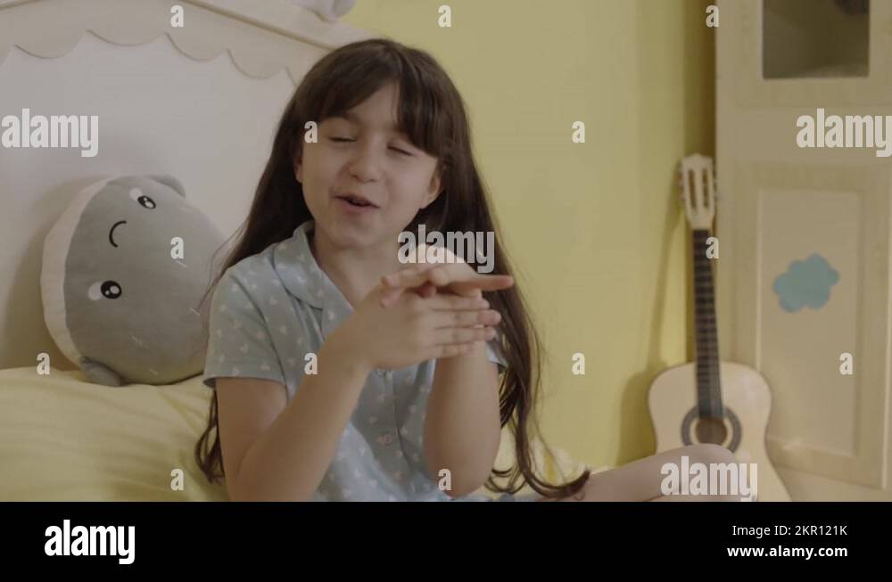 Little girl doing magic tricks with her fingers in the bedroom Stock Video Footage Alamy