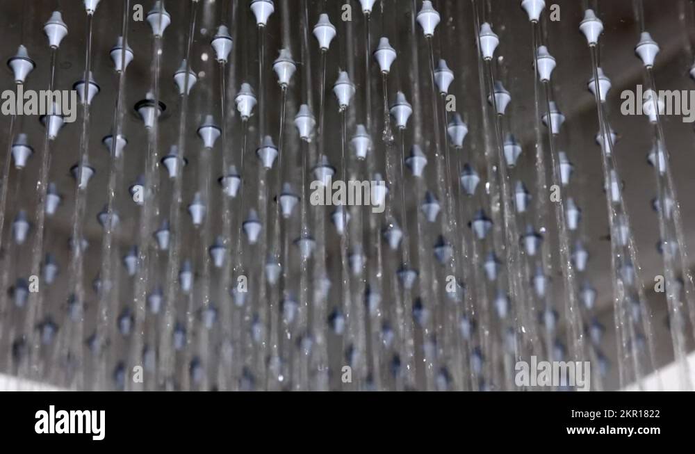 Water passing from the openings of the shower head in the modern
