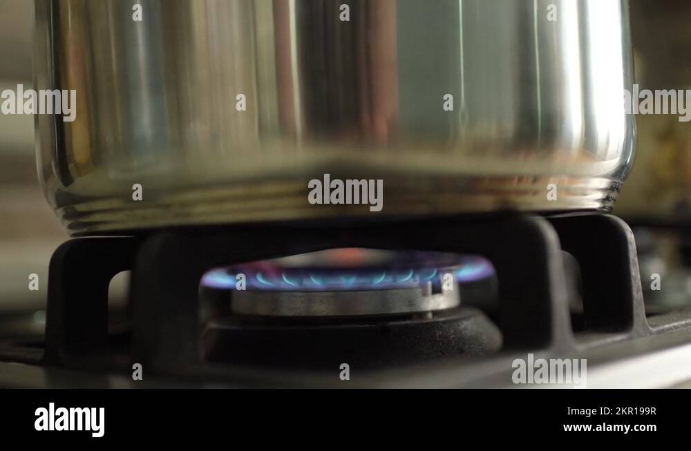 Big Steel Saucepan Standing on a Gas Stove Cooking a Meal Stock Video