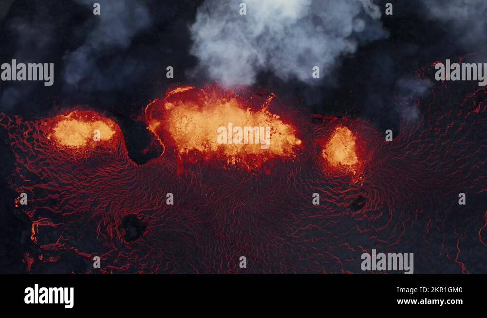 Top down view of active fissure volcano with hot molten lava spewing on ...