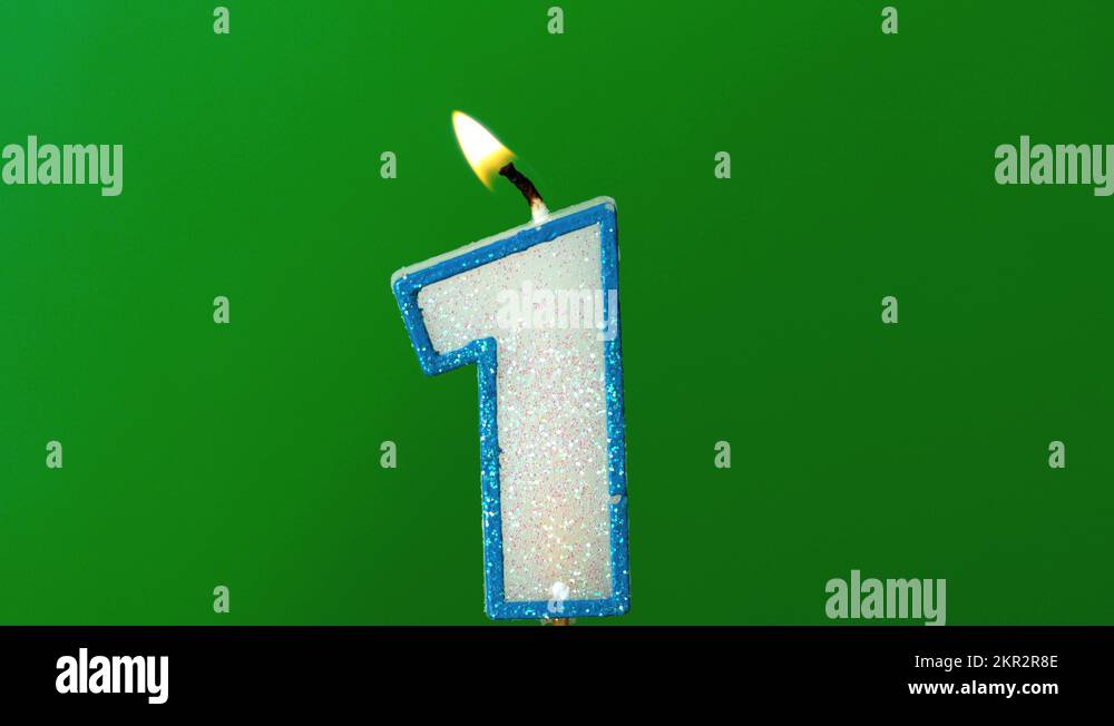 One birthday candle flickering and extinguishing on green background Stock Video Footage Alamy
