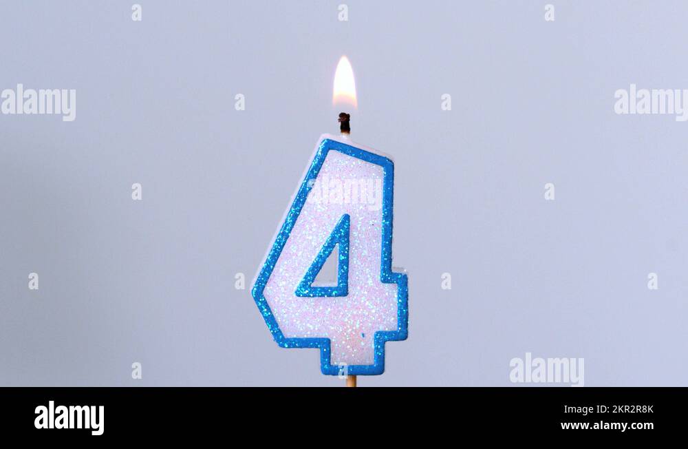 Four birthday candle flickering and extinguishing on blue background Stock Video Footage Alamy