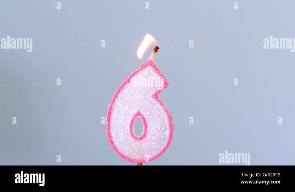 Six birthday candle flickering and extinguishing on blue background Stock Video Footage Alamy