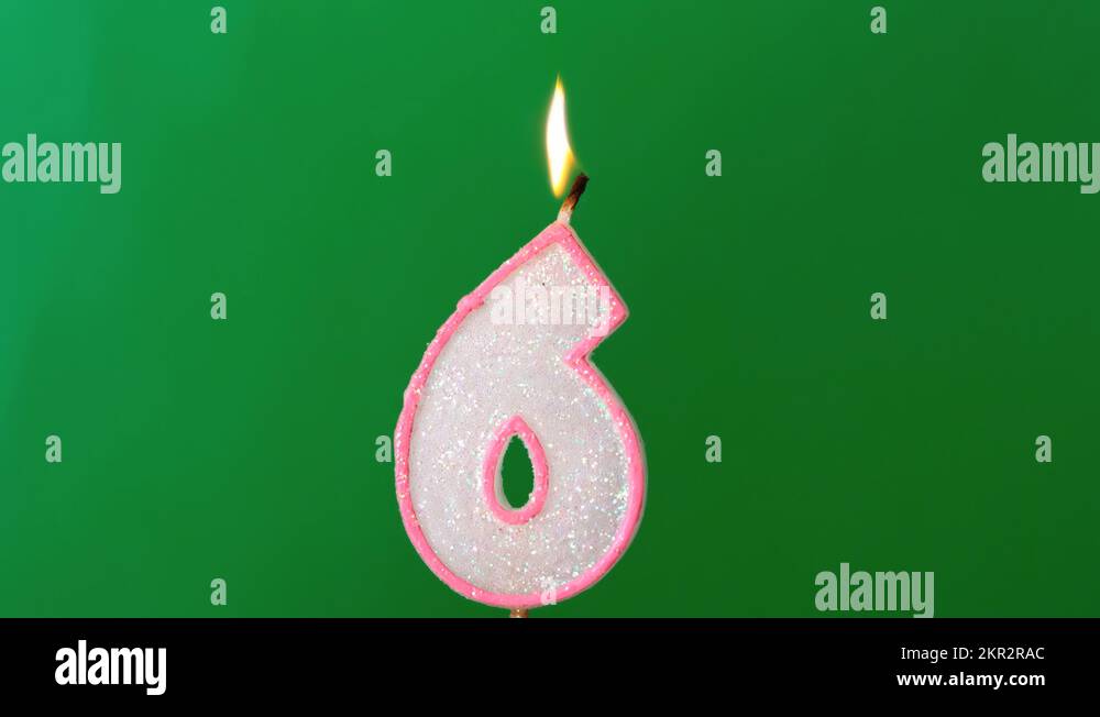 Six birthday candle flickering and extinguishing on green background Stock Video Footage Alamy