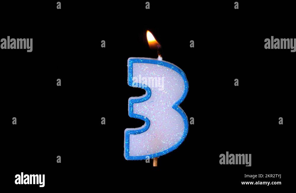 Three birthday candle flickering and extinguishing on black background Stock Video Footage Alamy
