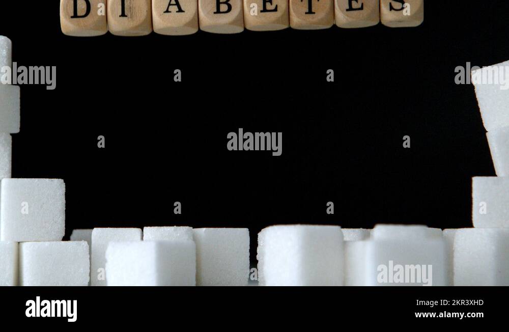 Sugar cubes and dice spelling diabetes falling down in black background