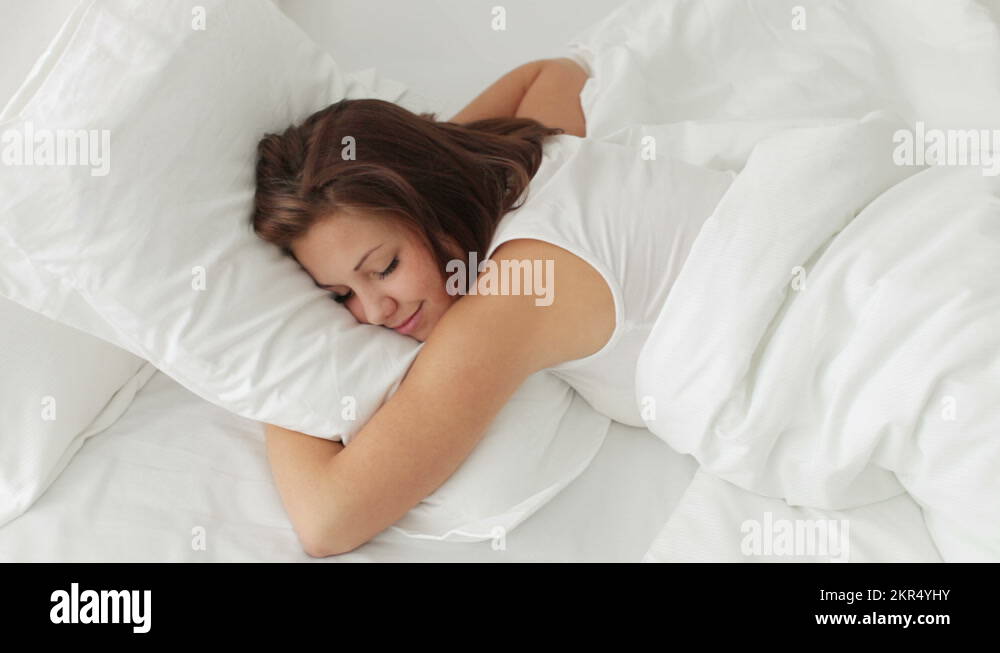 Cute girl sleeping on stomach waking up and yawning Stock Video Footage Alamy