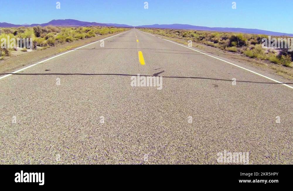 POV shot along a desert road driving fast Stock Video Footage Alamy