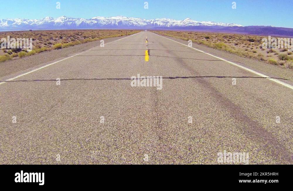POV shot along a desert road driving fast Stock Video Footage Alamy