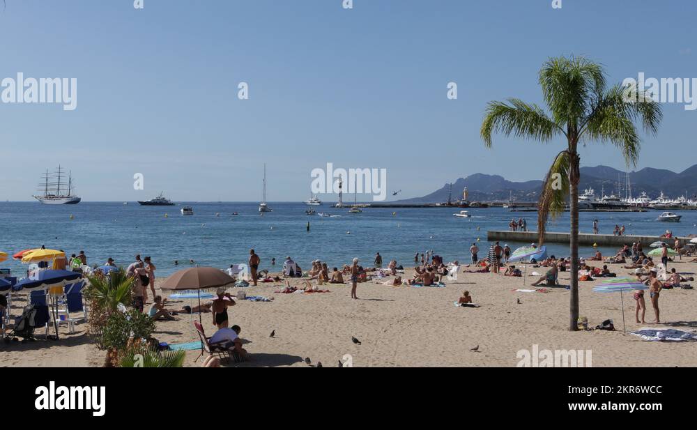 Ultra HD 4K French Riviera People sunbathing swimming beach umbrella