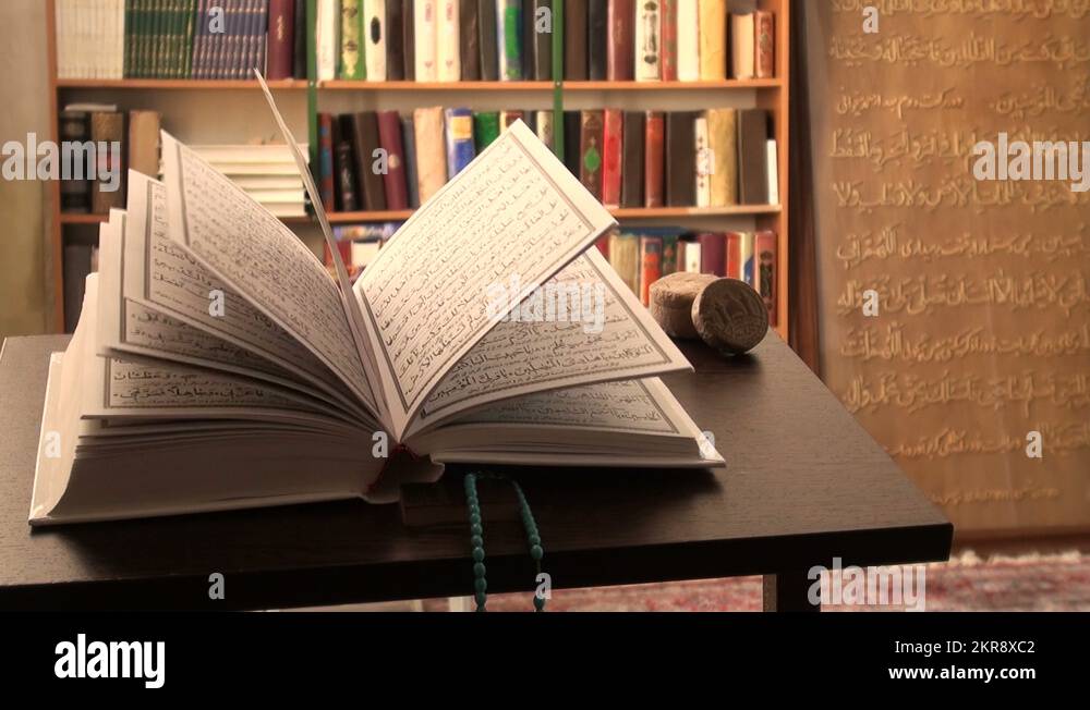 Turning pages of the Holy Quran Koran inside an Islamic mosque in Iran