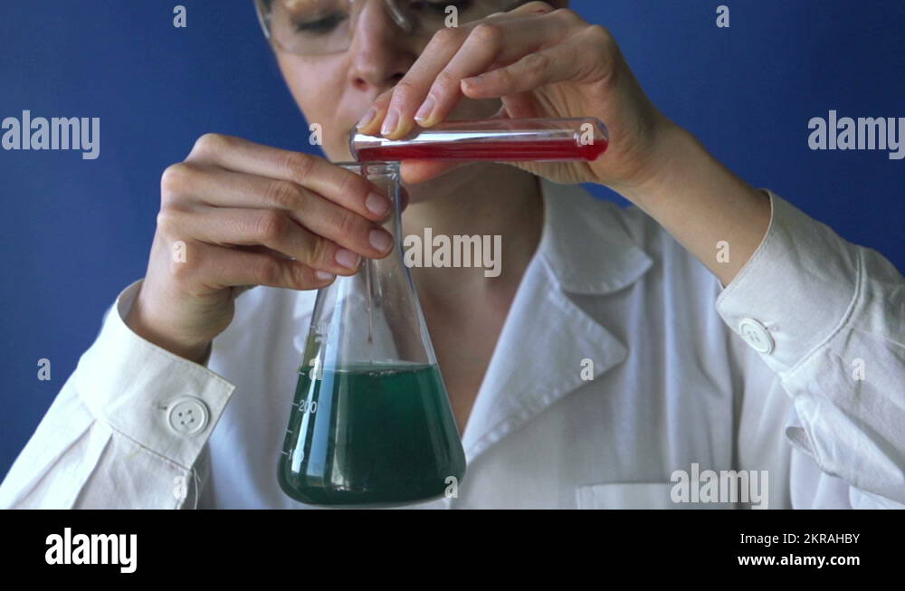 Scientist pouring chemicals into erlenmeyer flask in lab HD Stock Video