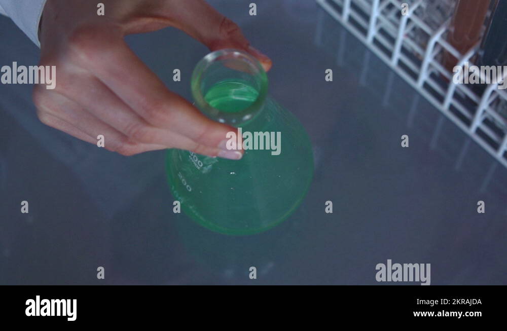 Pouring, mixing chemicals in erlenmeyer flask HD Stock Video Footage Alamy