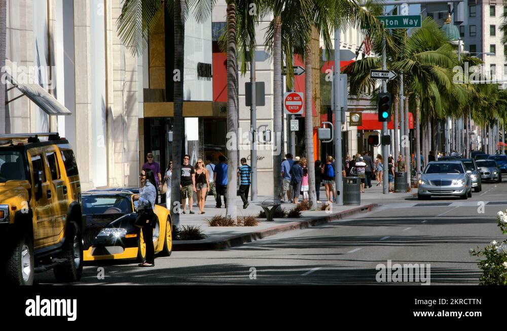 Luxury cars drive on Rodeo Drive in Beverly Hills in Los Angeles