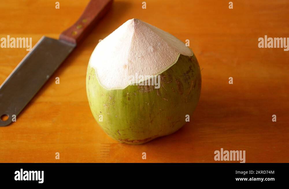 Chopping Green Coconut for Fresh Drink. Traditional Thailand Drink