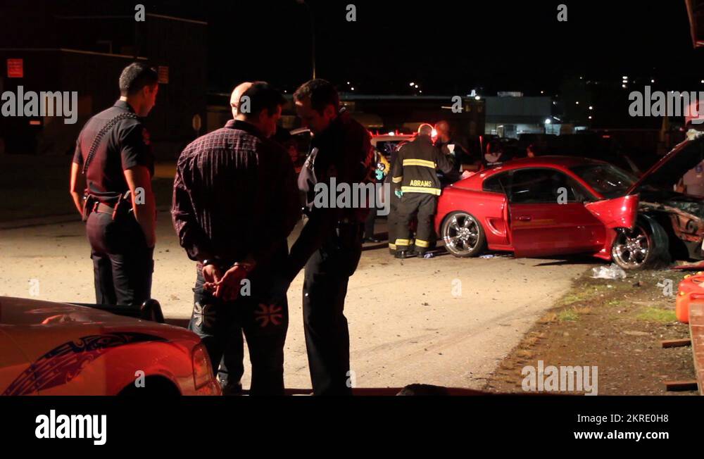 Driver with handcuffs at car crash scene Stock Video Footage Alamy