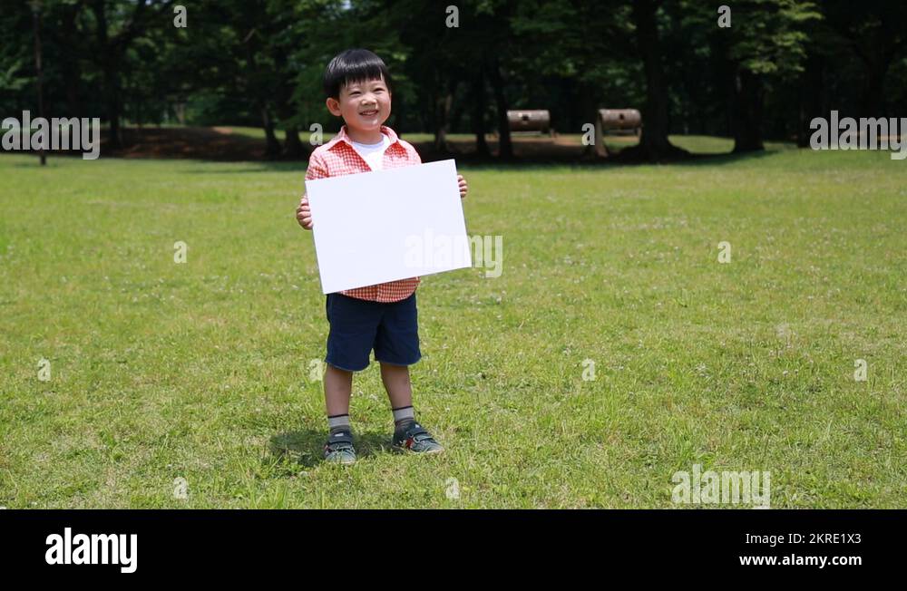 Japanese kid with whiteboard in a park, Tokyo, Japan Stock Video