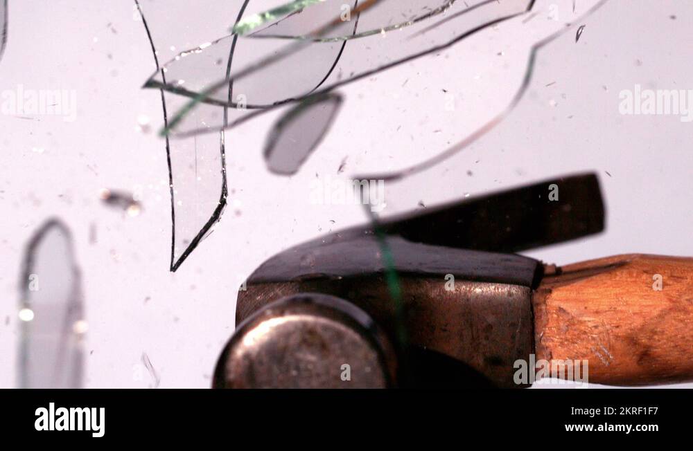 Hammer smashing through pane of glass Stock Video Footage Alamy