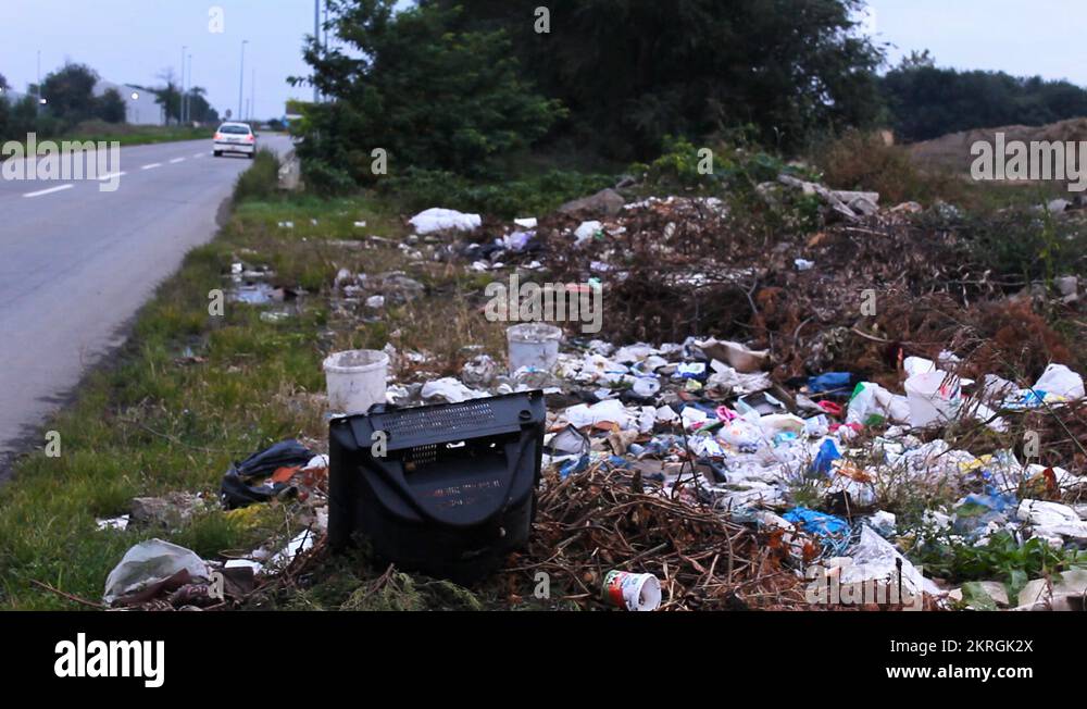 dump trash by the road traffic near dump old television Stock Video