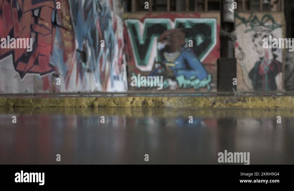Raining inside a graffited industrial building Stock Video Footage Alamy