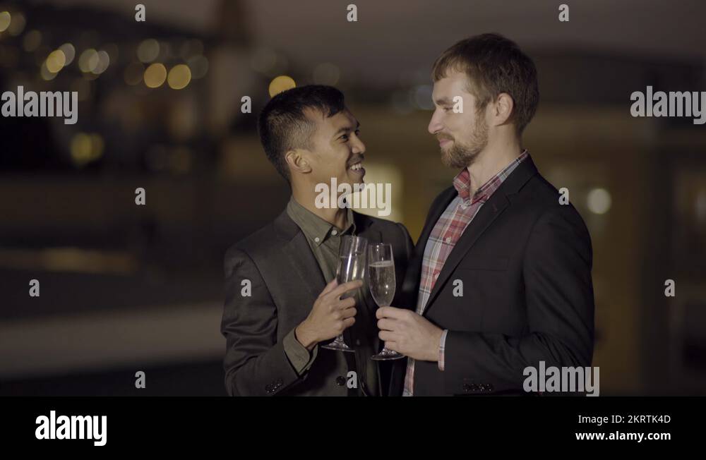 Gay Couple Celebrate, Toast With Champagne, And Kiss On A Rooftop(4K