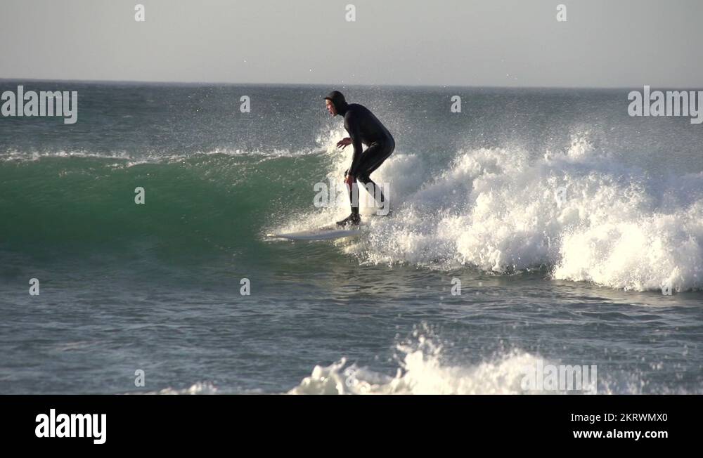Slow motion of a Surfer riding the waves at a beach in Cape Town, South