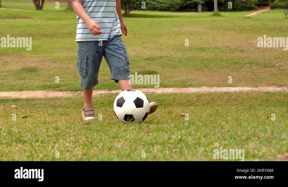 Little boy playing with a soccer ball in the park Stock Video Footage