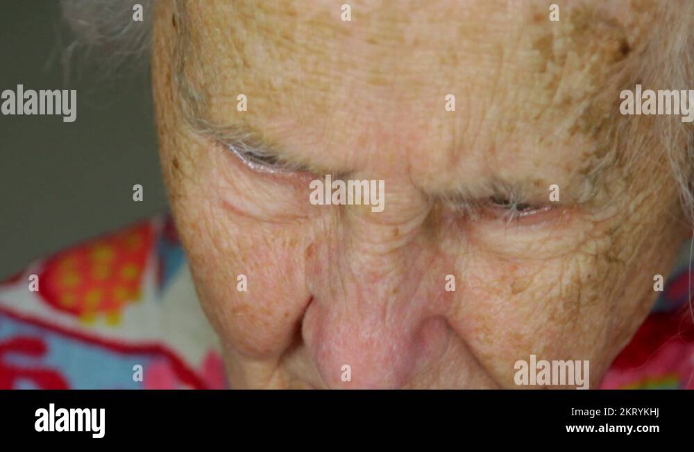 Very Old Lady Reading A Book With A Magnifying Glass, Poor Vision, Tilt