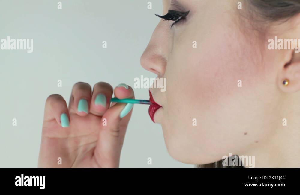Beautiful, Sexy Woman Sucks Sweet. Red Lipstick on her lips Stock Video