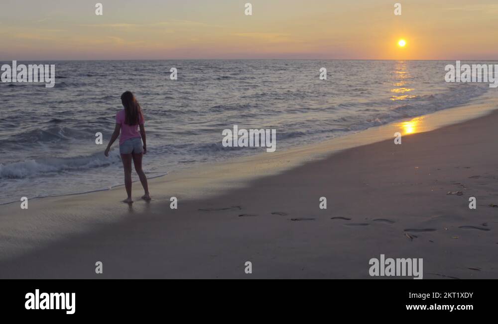 Teen Girl Stands Close To Waves, She Runs Away When They Get Close (4K