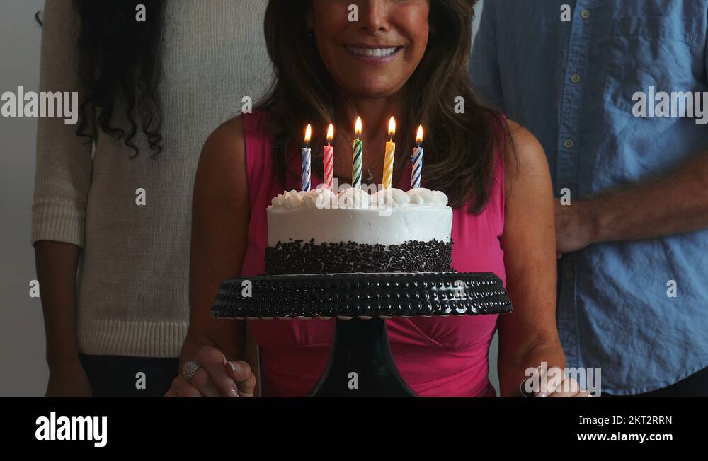 4K Mature Woman Blowing Out Candles On A Birthday Cake And Laughing