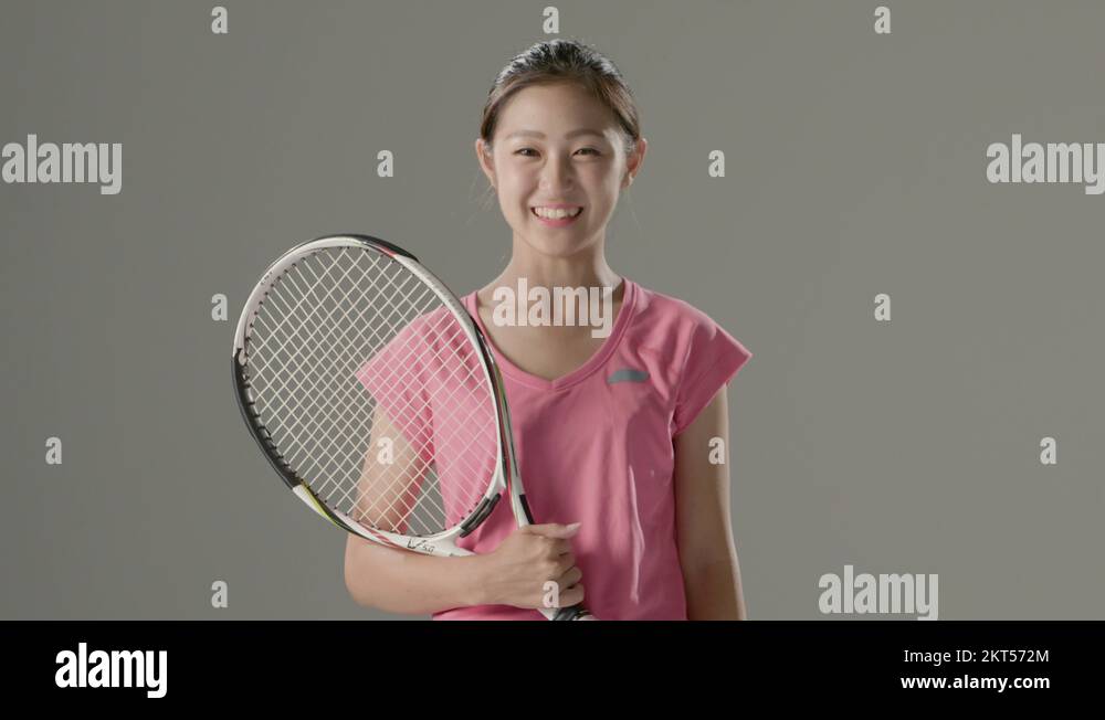 Young Japanese female tennis player in action against grey background Stock Video Footage Alamy