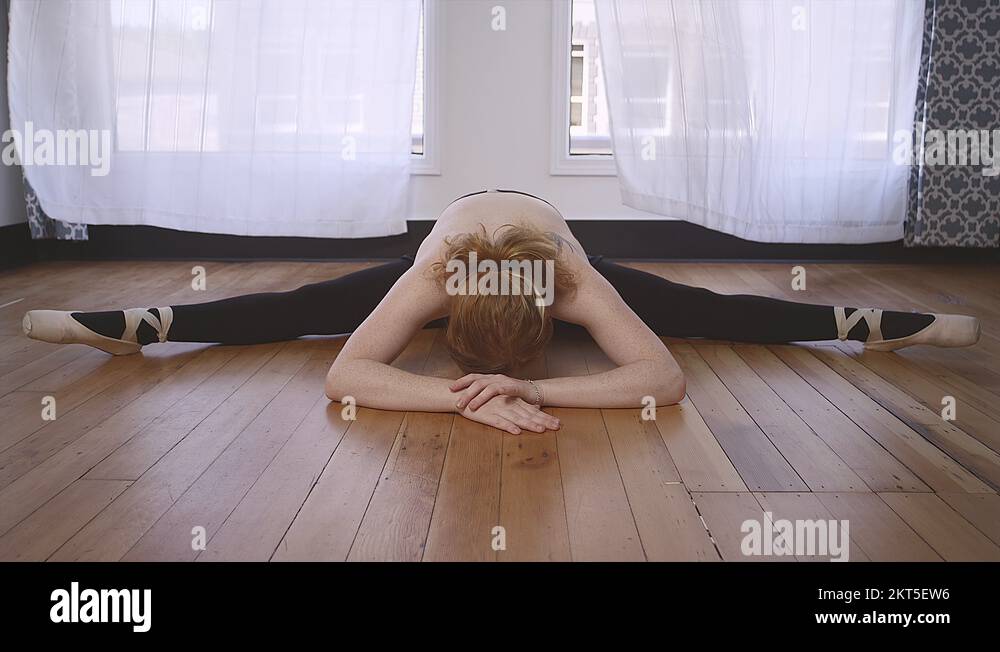 A ballet dancer raising from the splits in a studio Stock Video Footage ...