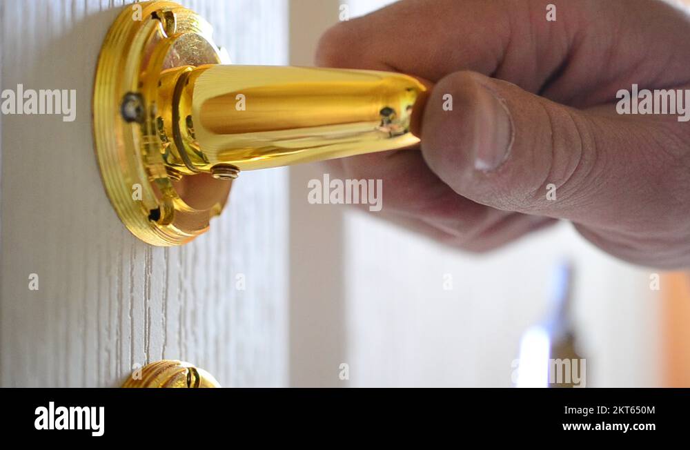 Mounting a mortise door lock. Fastening door handle screw Stock Video