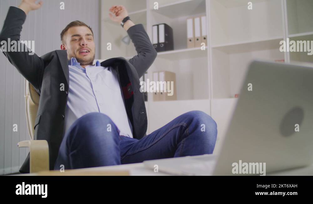 The young businessman stopped working and leaned back on a chair Stock