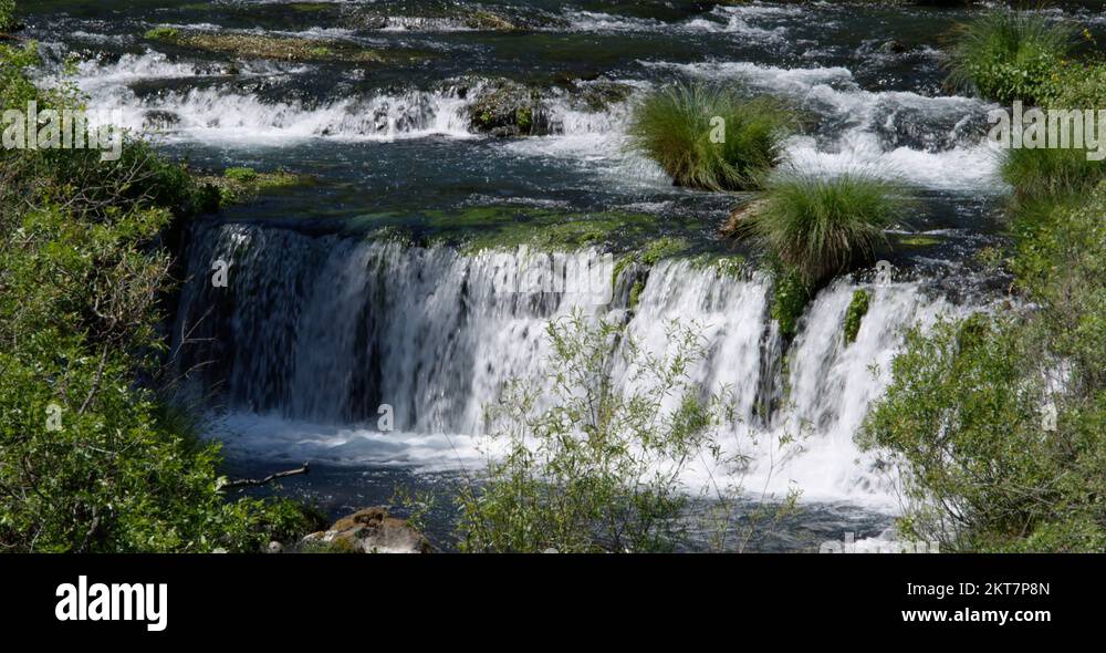 Water pooling at base of stairstepped low waterfall Stock Video
