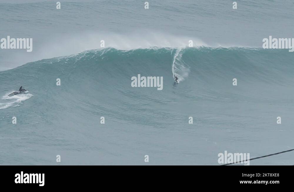Big wave surfers ride huge waves Stock Video Footage Alamy