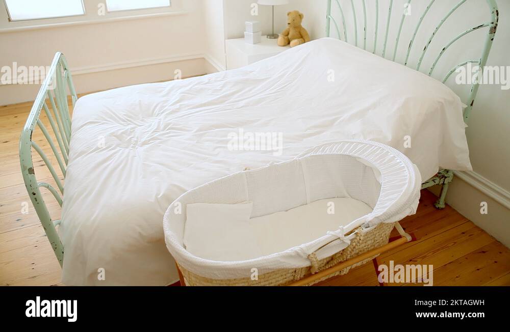 Tired mother putting baby in and lying on bed Stock Video