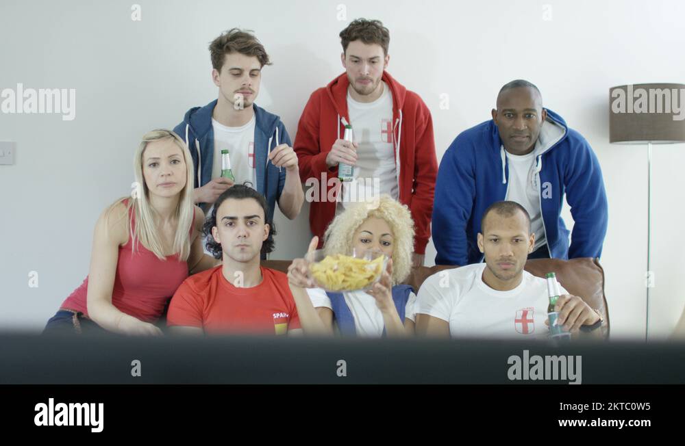 4K Group of friends watching sports game on TV celebrate when team