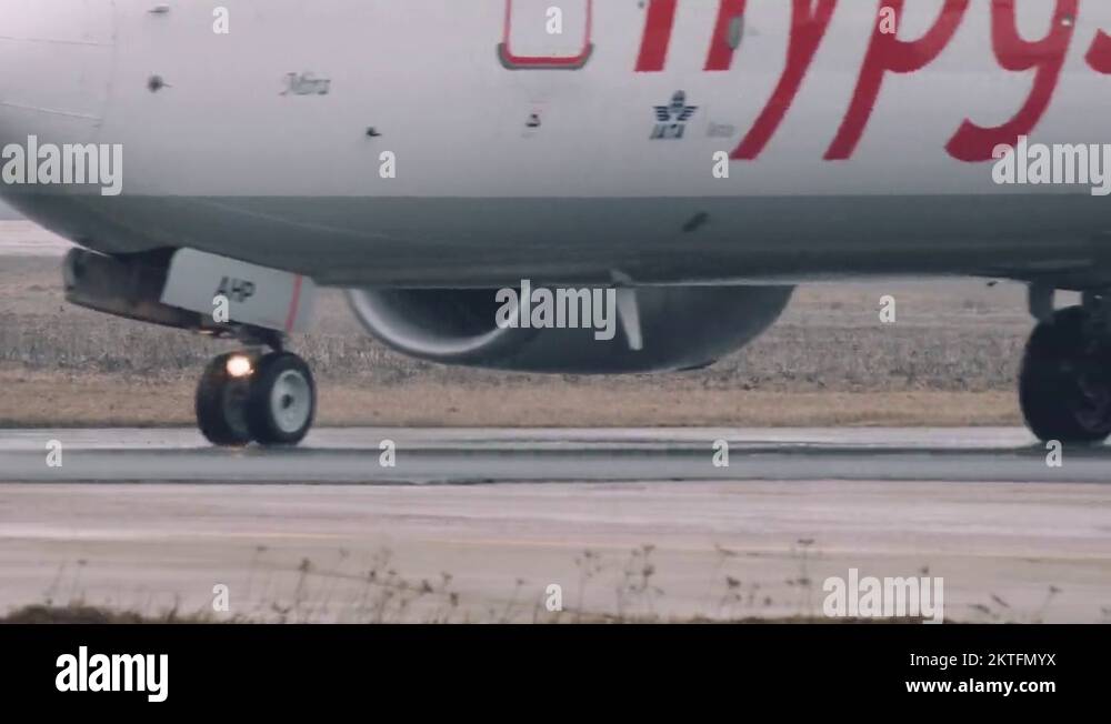 Wheels and turbines of an 737800 boeing moving on a runway in the
