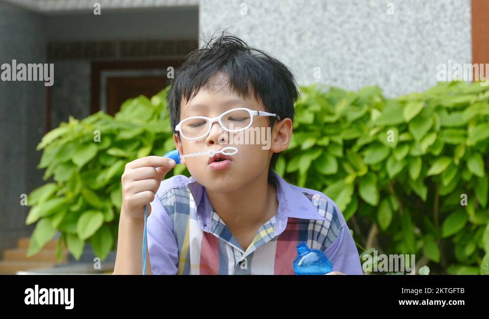 Young Boy Blowing Bubbles Stock Video Footage - Alamy