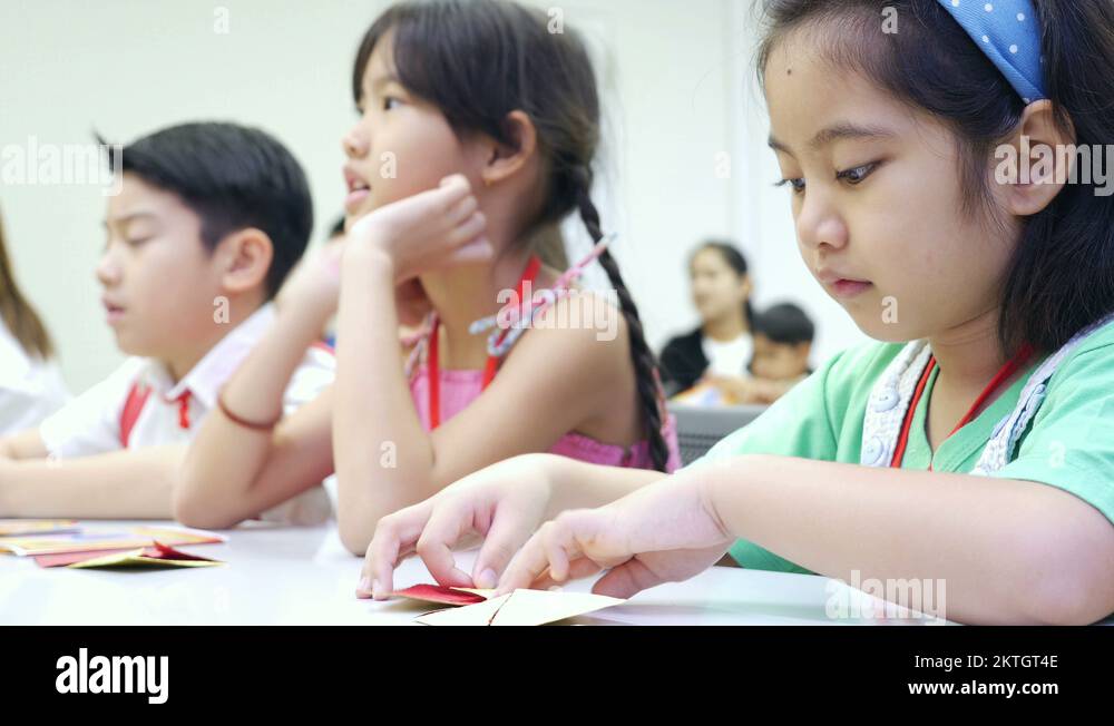 4K : Asian child learning to folding Japanese paper origami Stock Video ...