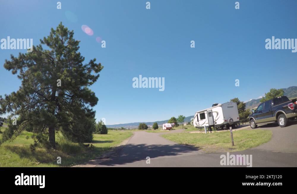 Car driving through campground with motorhomes at Chatfield State Park